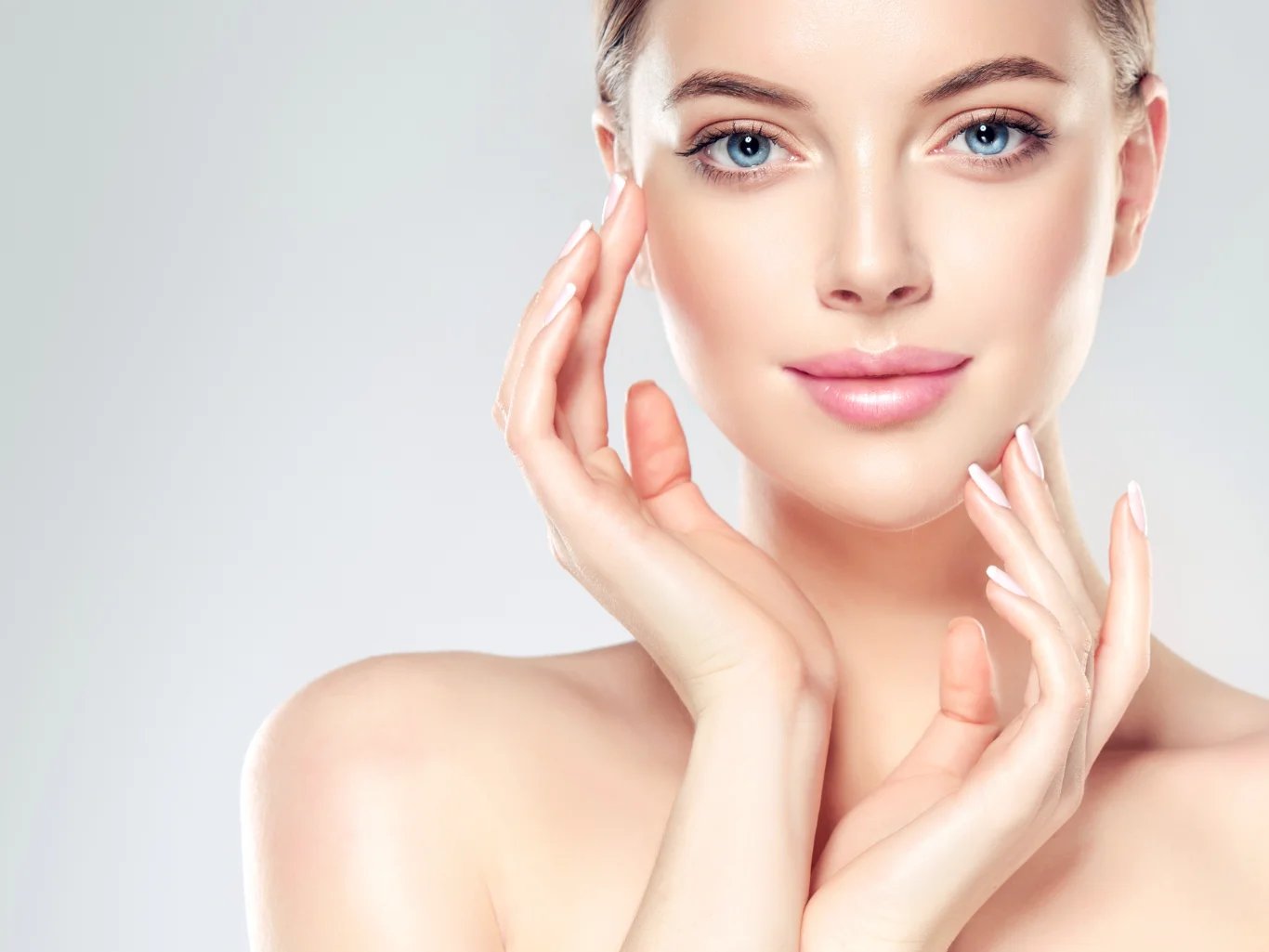 Beautiful Young Woman with Clean Fresh Skin touch own face