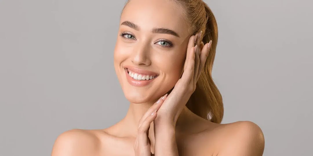 beautiful smiling woman touching her face